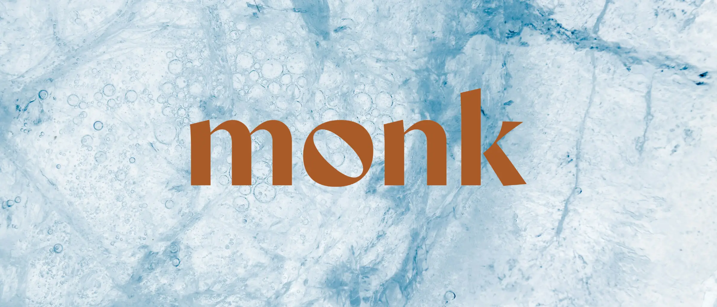 The Monk wordmark in copper on a background of ice