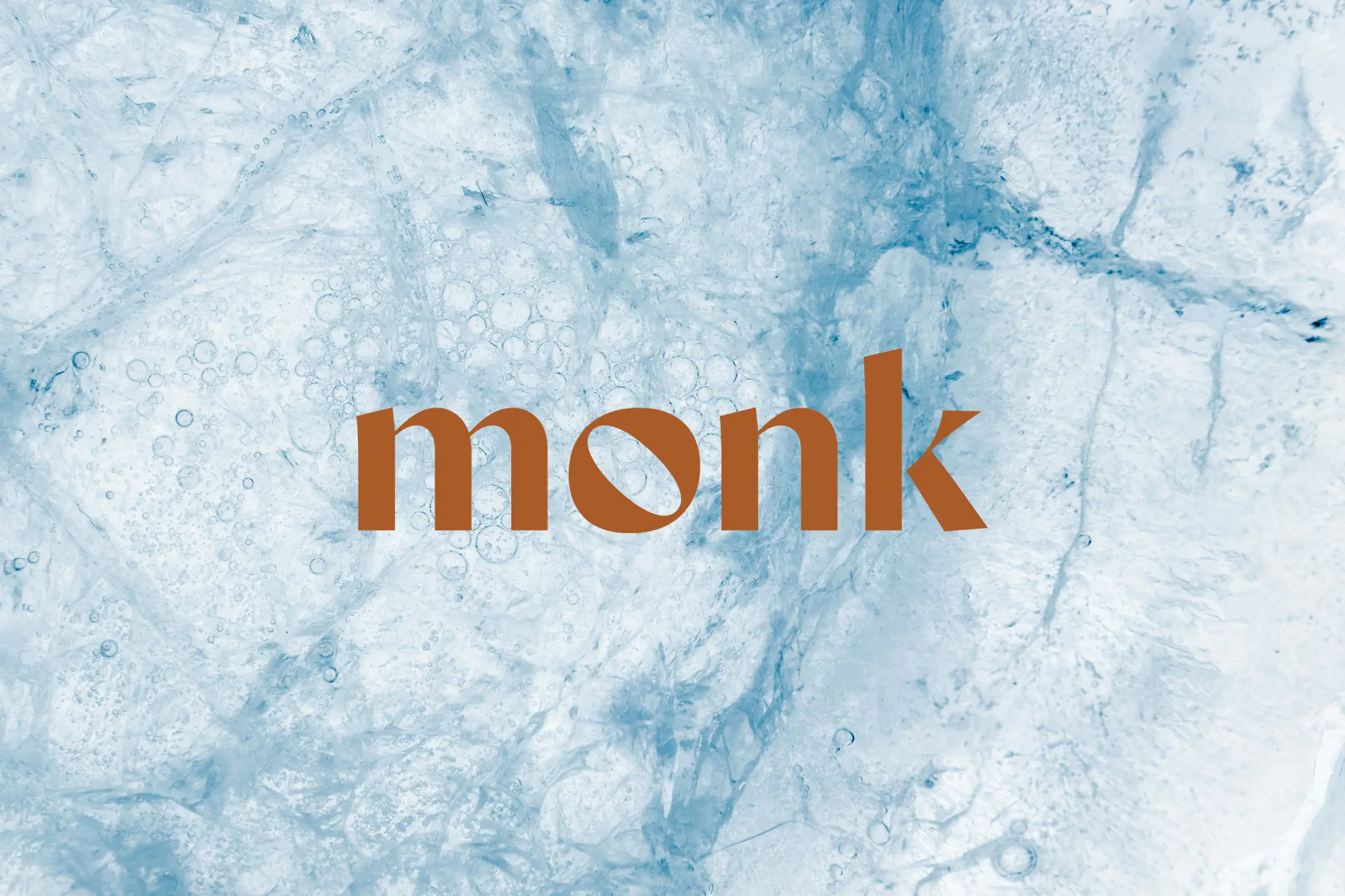 The Monk wordmark in copper on a background of ice
