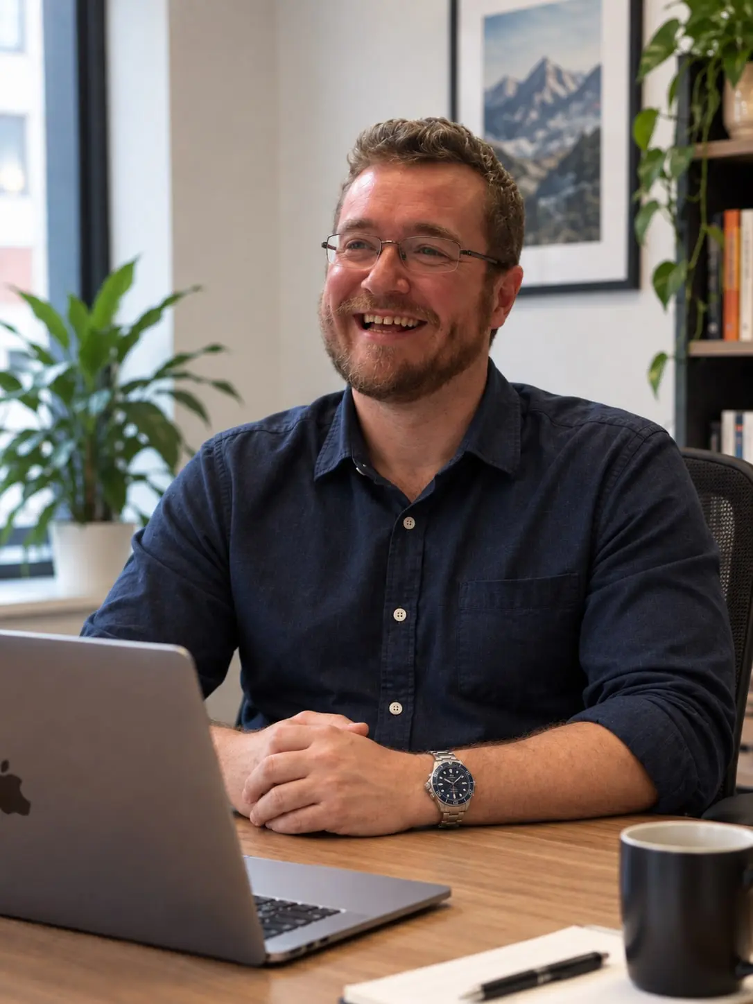 Benjamin Edwards at his desk, laptop open, mid-conversation